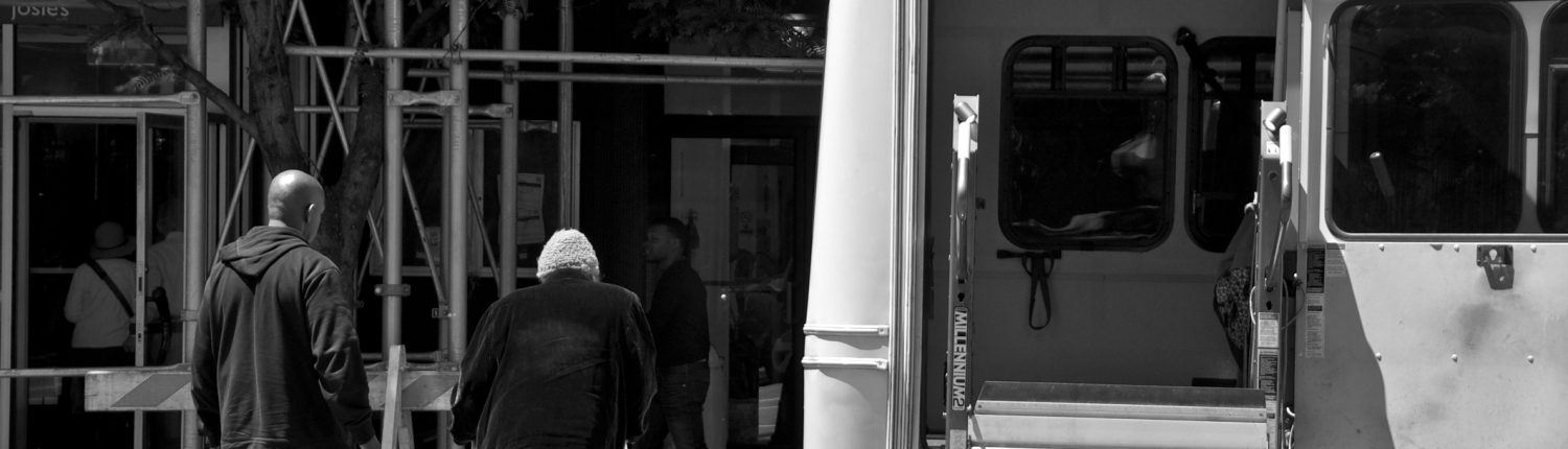Senior female being helped to building entrance, New York City