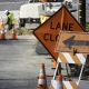 Road construction work being done with lanes closed sign